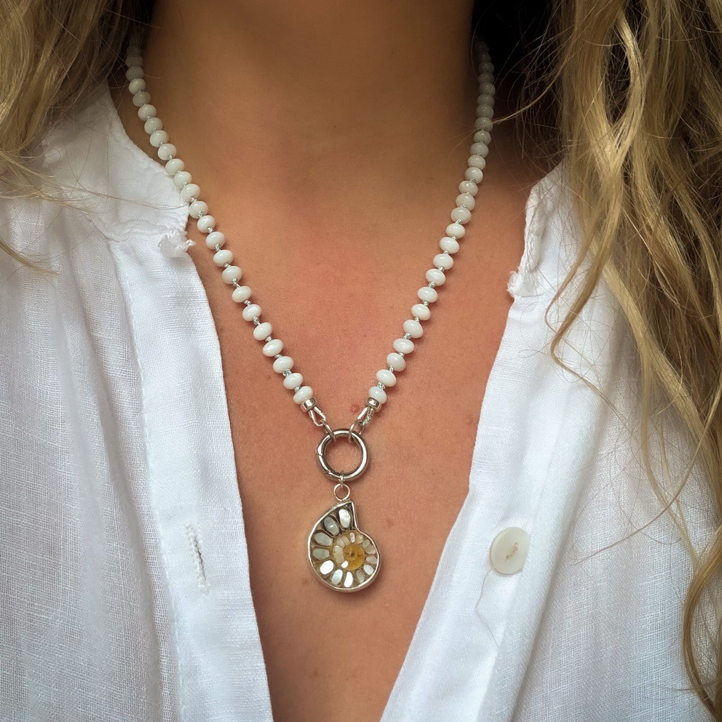 Mother of pearl beaded necklace hand knotted on light blue silk thread. Natural earth collective OH