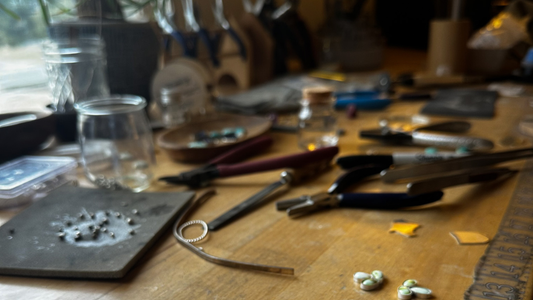Jewelry making bench with sterling silver tools and natural stones, handcrafted jewelry studio Natural Earth Collective Ohio