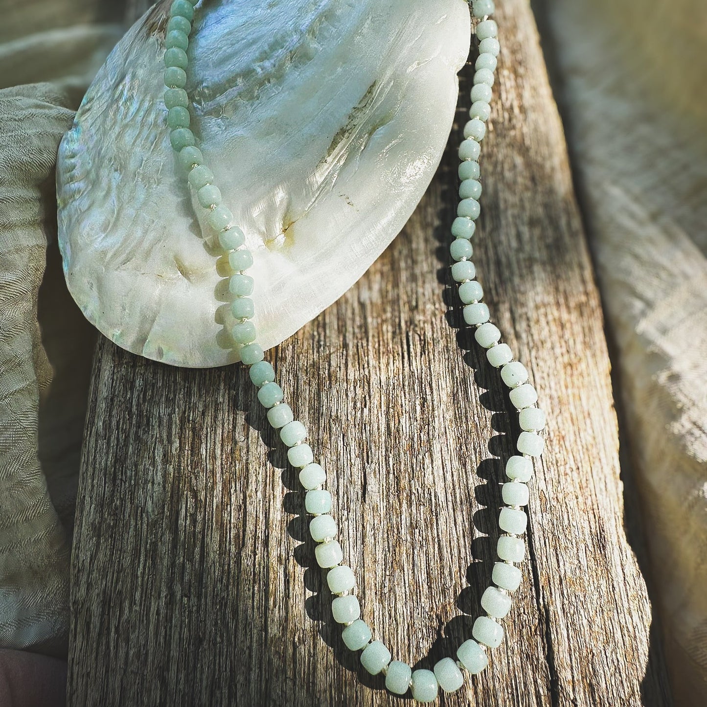Pale green Amazonite drum beaded necklace, hand knotted on cream silk thread. Natural Earth Collective Ohio