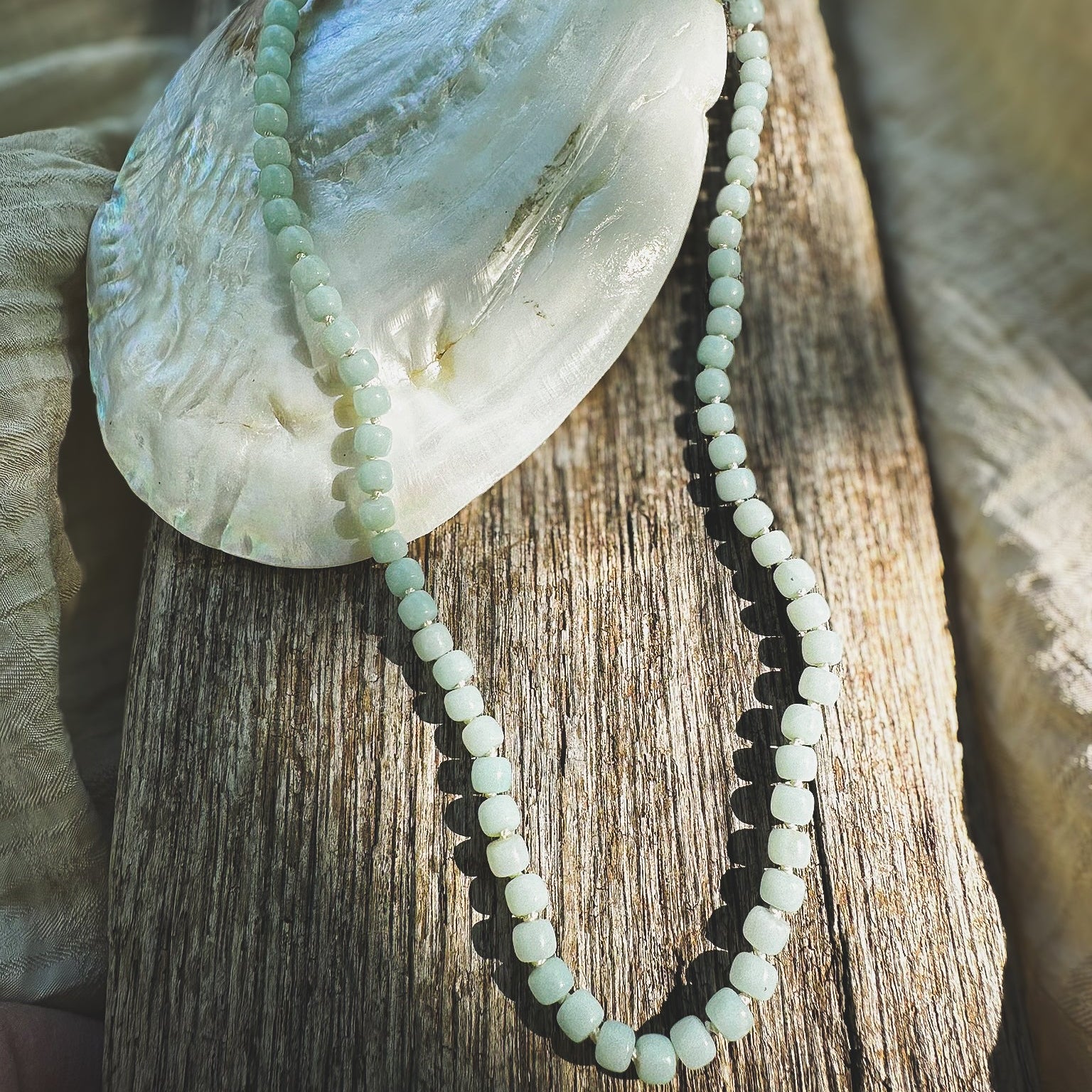 Pale green Amazonite drum beaded necklace, hand knotted on cream silk thread. Natural Earth Collective Ohio