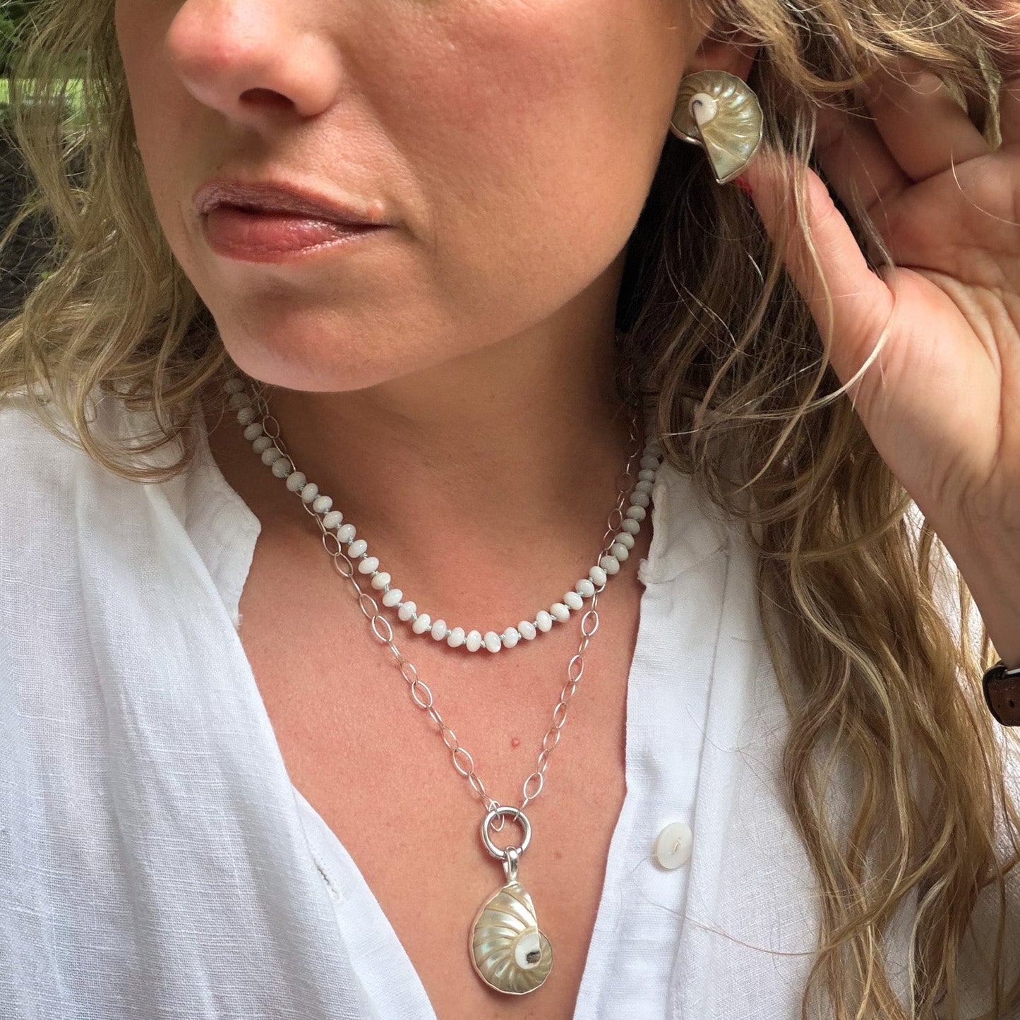 Mother of pearl beaded necklace hand knotted on light blue silk thread. Natural earth collective OH