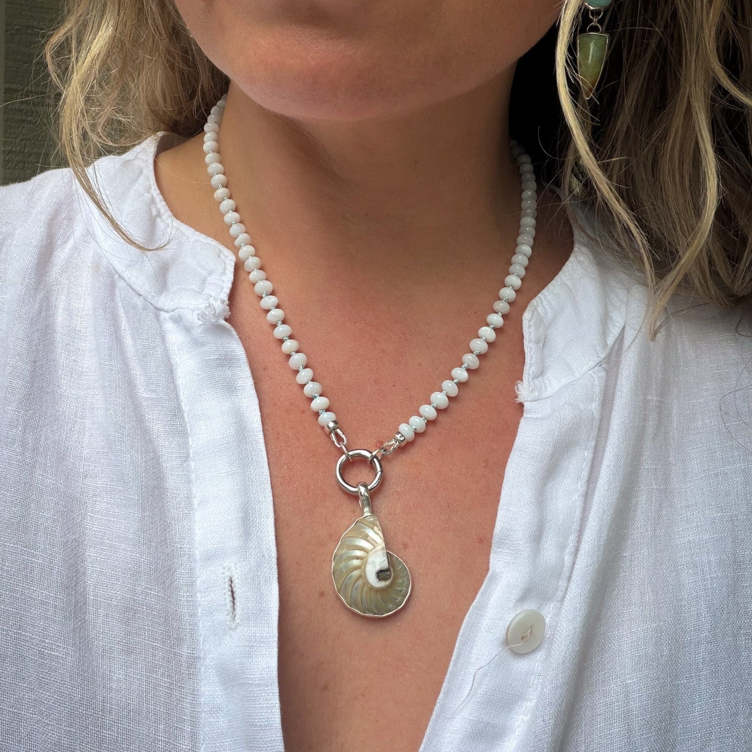 Mother of pearl beaded necklace hand knotted on light blue silk thread. Natural earth collective OH