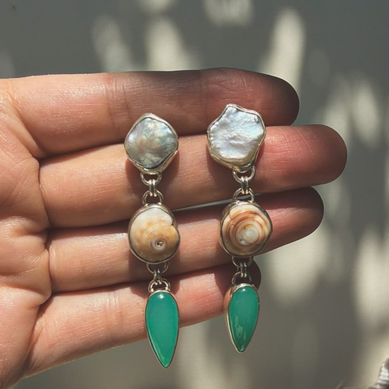 Pearl, puka shell, teal chalcedony tiered dangle earrings in sterling slilver earrings. Natural earth collective OH