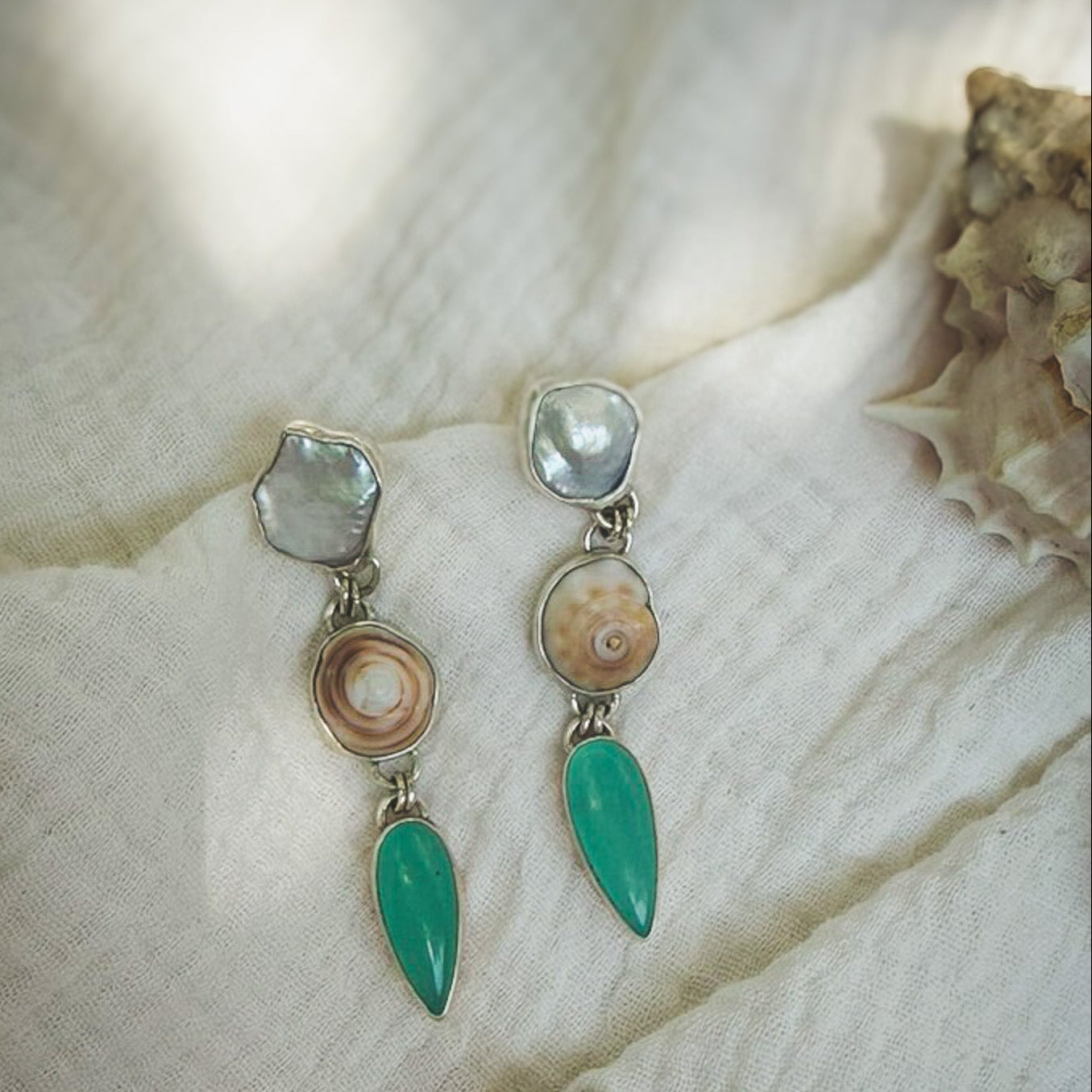 Pearl, puka shell, teal chalcedony tiered dangle earrings in sterling slilver earrings. Natural earth collective OH