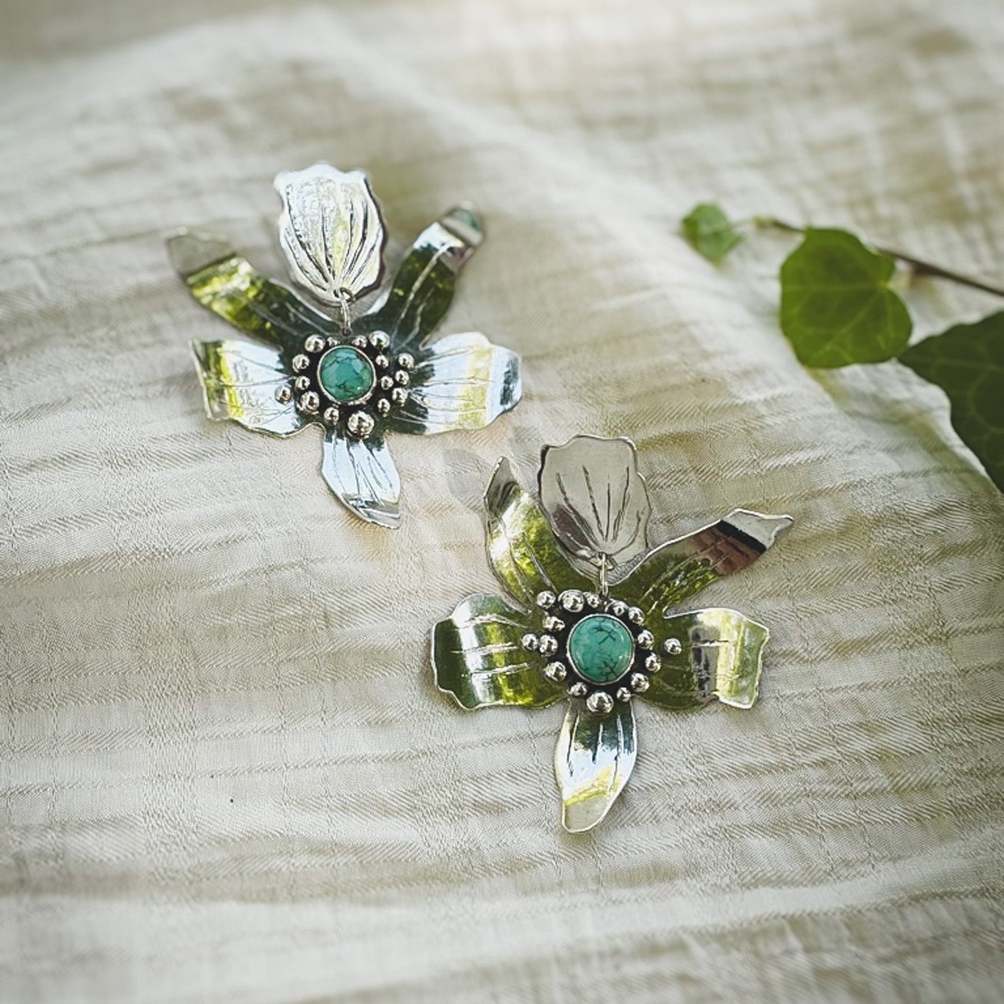 Hand fabricated sterling silver flower statement post earrings with #8 mine turquoise set in the centers. Natural Earth Collective Ohio 