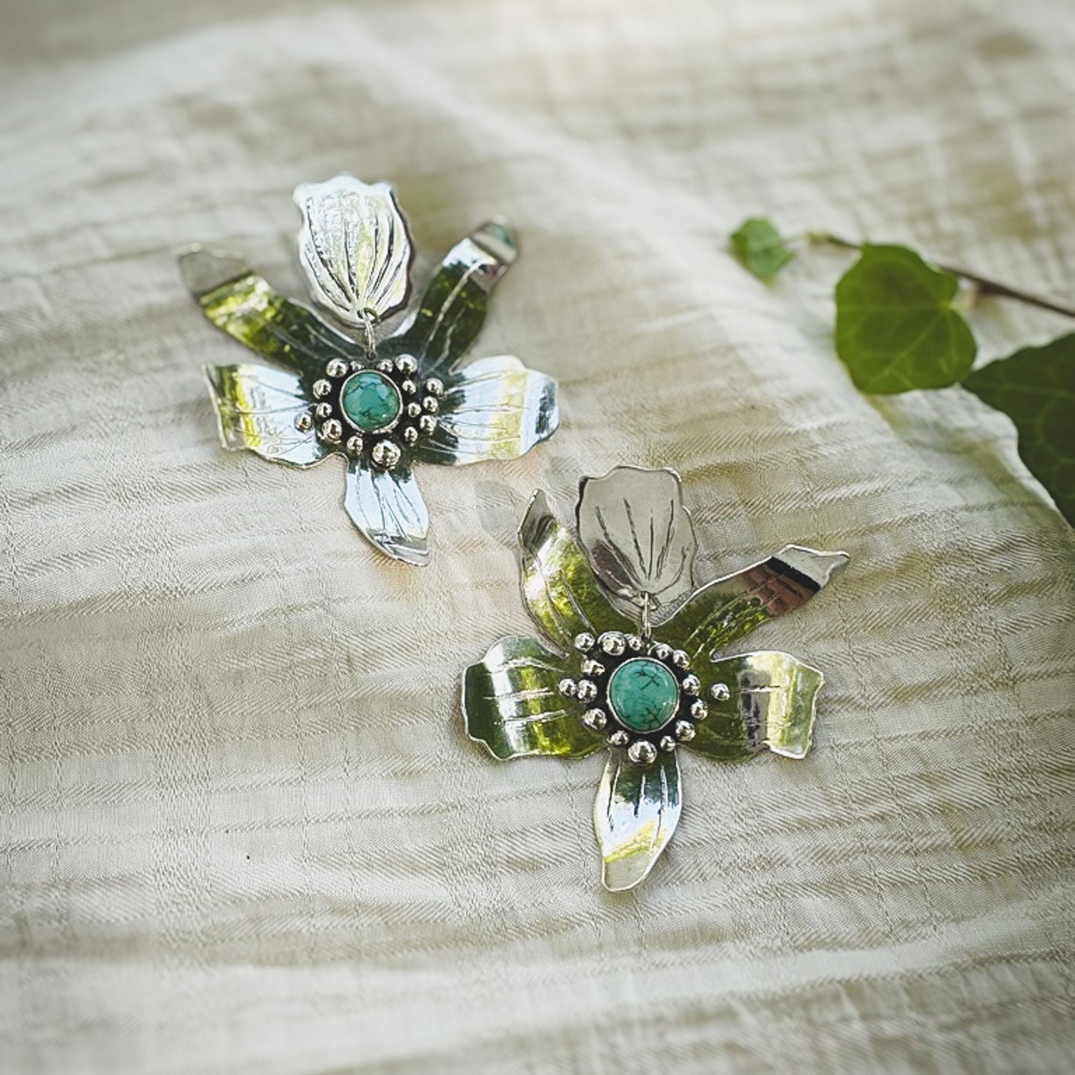 Hand fabricated sterling silver flower statement post earrings with #8 mine turquoise set in the centers. Natural Earth Collective Ohio 